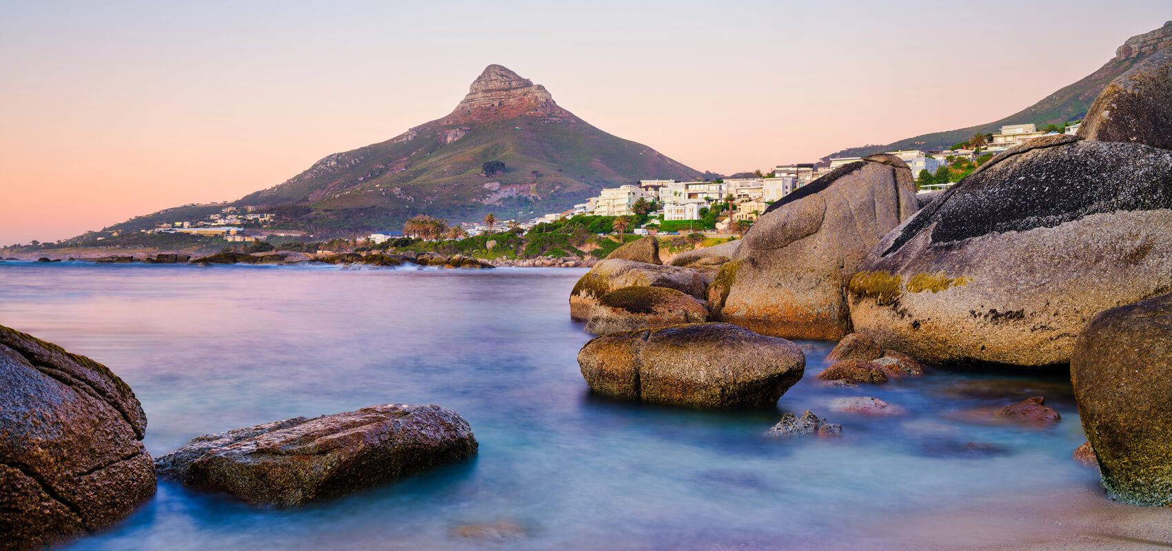 Stunning view of Clifton Beach with its iconic boulders and turquoise waters and Lion’s Head in the distance.