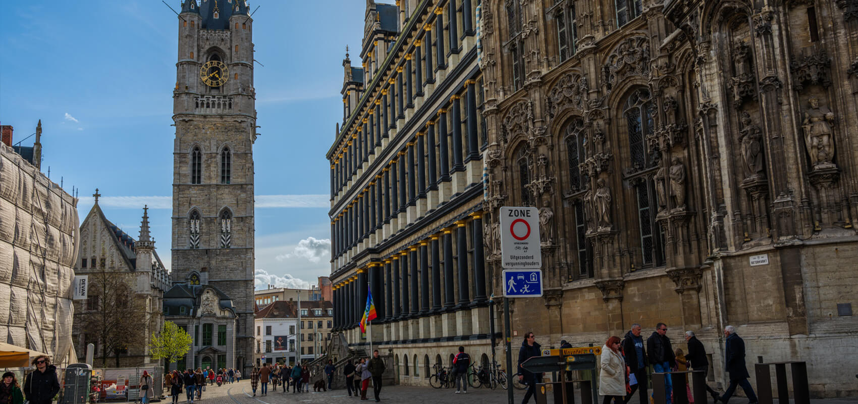 View of the Ghent Belfry tower against a blue sky