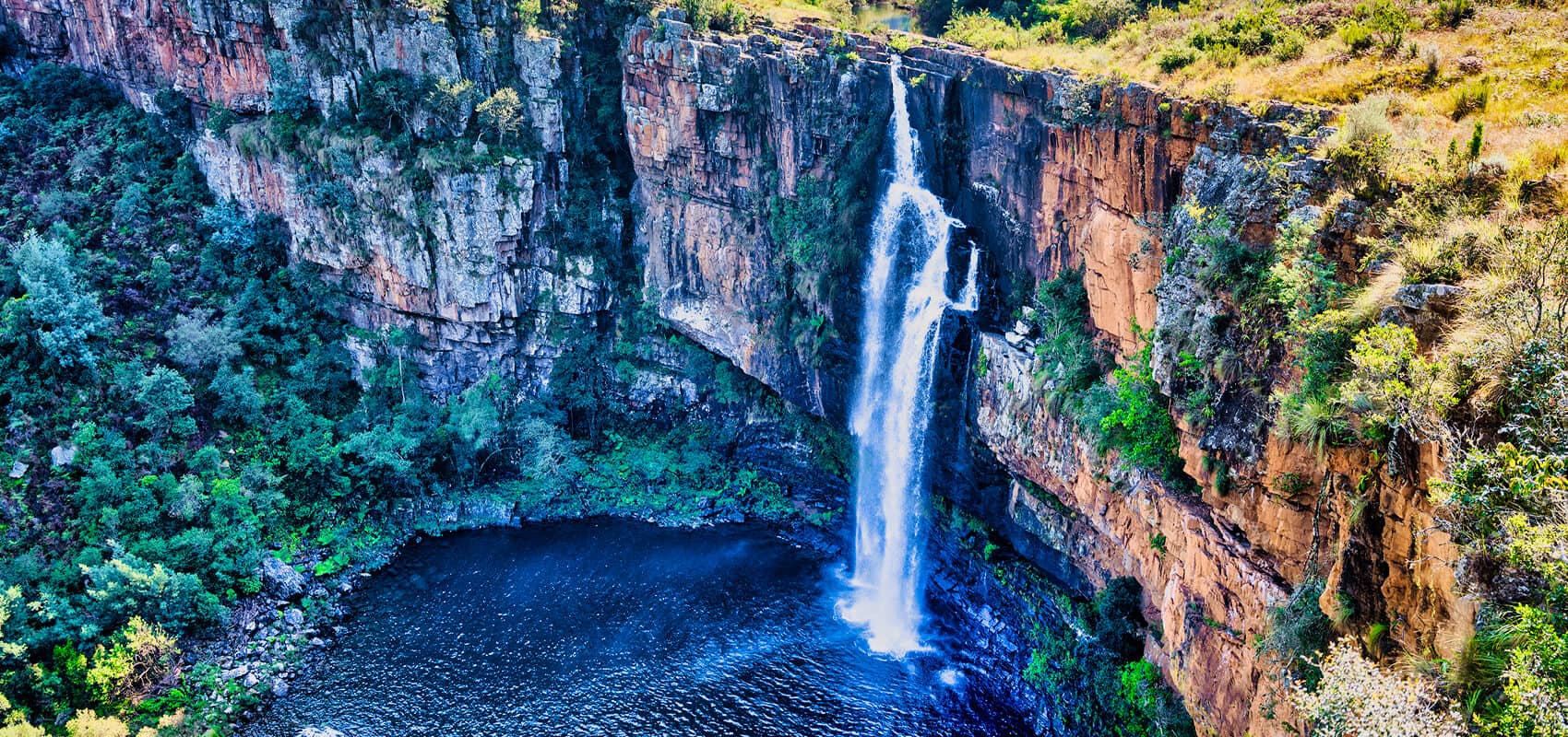 Picturesque view of Berlin Falls with its pristine crystal pool, Panorama Route, South Africa.