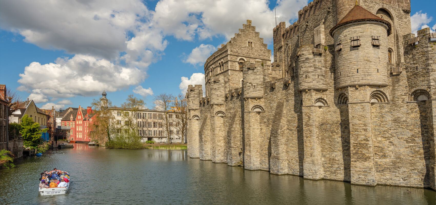 Exterior view of the formidable medieval Gravensteen Castle with its moat in Ghent