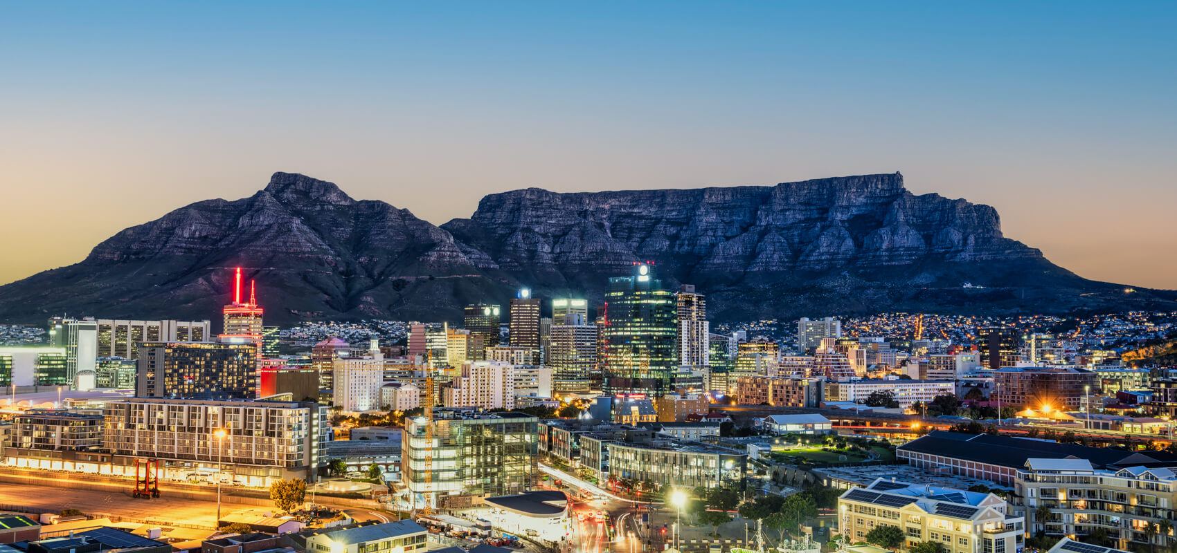 Panoramic view of Table Mountain overlooking Cape Town lit up at night