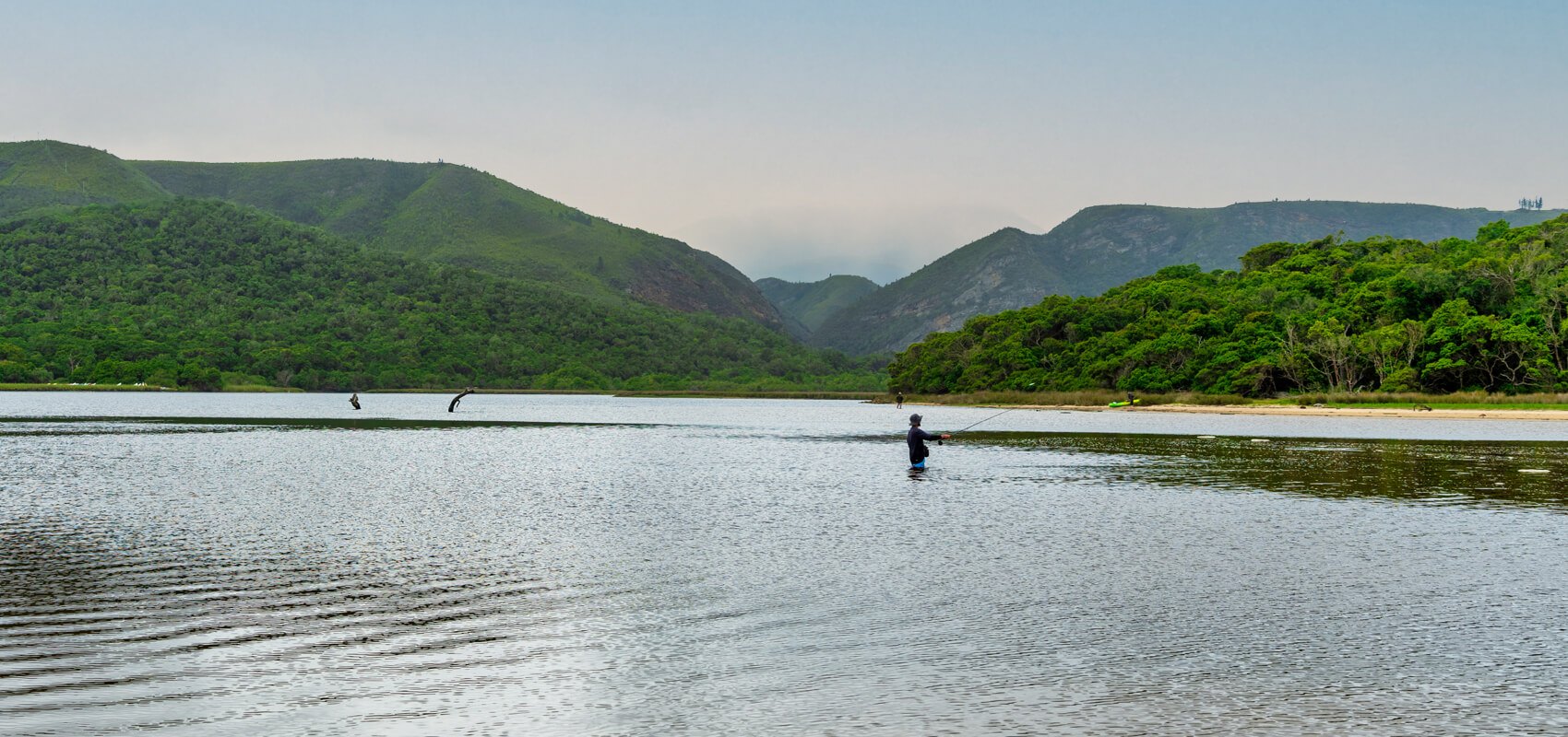 Fly-fishing in the tranquil lagoon of Nature's Valley, Garden Route, South Africa